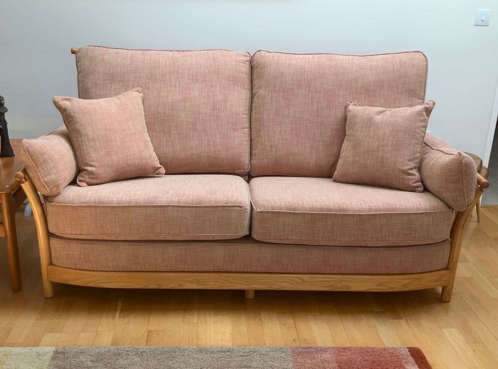 An Ercol sofa with new bespoke seat, arm and backrest cushions