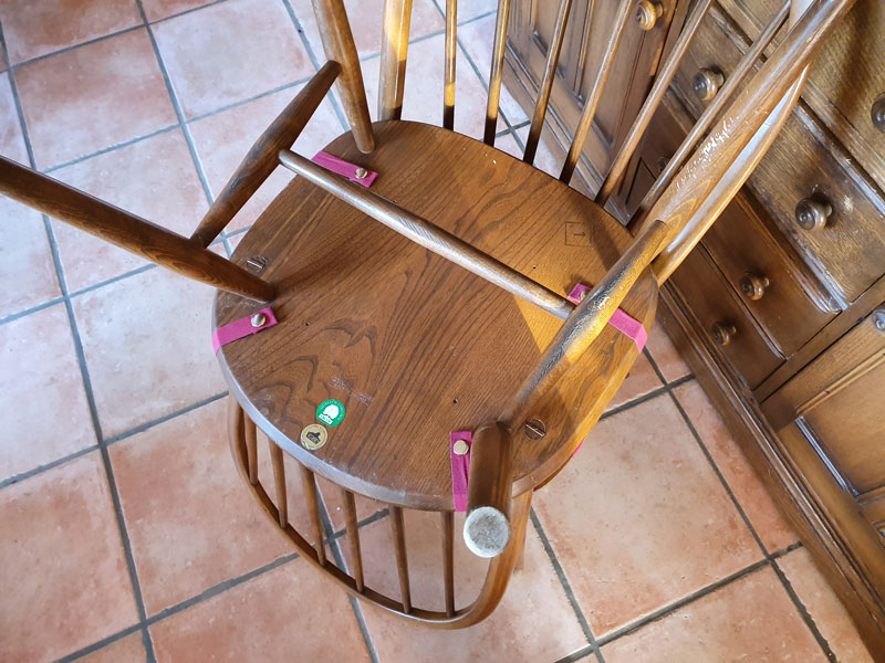 New Ercol dining chair cushions showing the webbing and stud fastenings